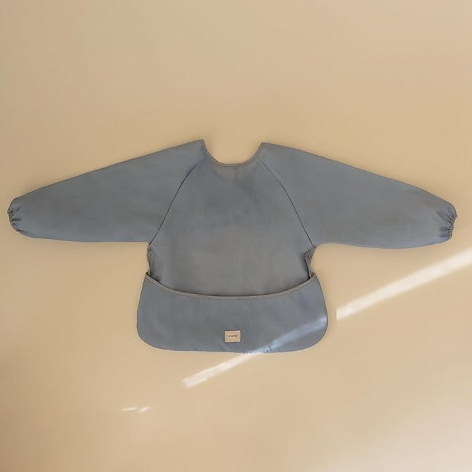 mushie Long Sleeve Baby Bib | Water Resistant Adjustable Fit for Ages 6-24 Months
