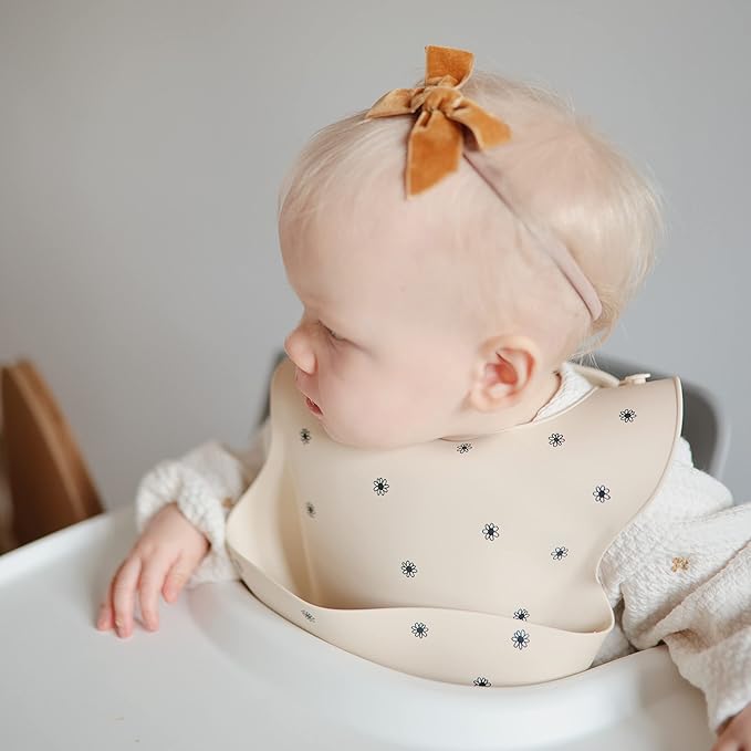 mushie Silicone Baby Bib | Adjustable Fit Waterproof Bibs (Black Daisy)