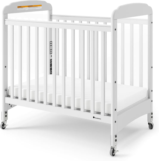 Foundations Serenity Compact Clearview Daycare Crib, Fixed Side, Durable Wood Construction, Non-Marking Casters (2 Locking), Clear End Panels, Includes 3” InfaPure Foam Mattress (White)